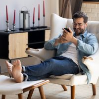 Handsome,30s,Single,Man,Relaxing,On,Comfy,Armchair,Put,Feet