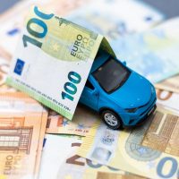 Toy,Car,And,Euro,On,White
